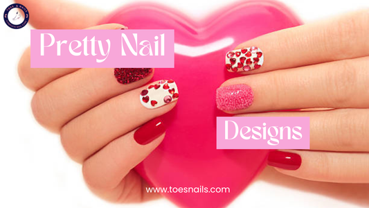 Hands with red and pink glitter nail designs holding a pink heart