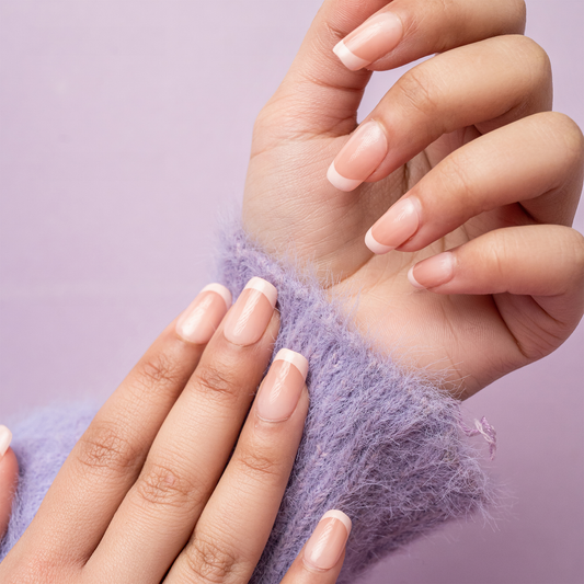 Hands wearing natural-looking French tip press-on nails