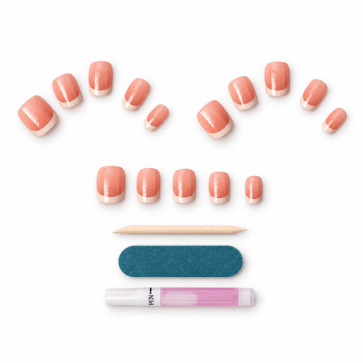 French tip press-on nails laid out with a nail file, cuticle stick and nail glue