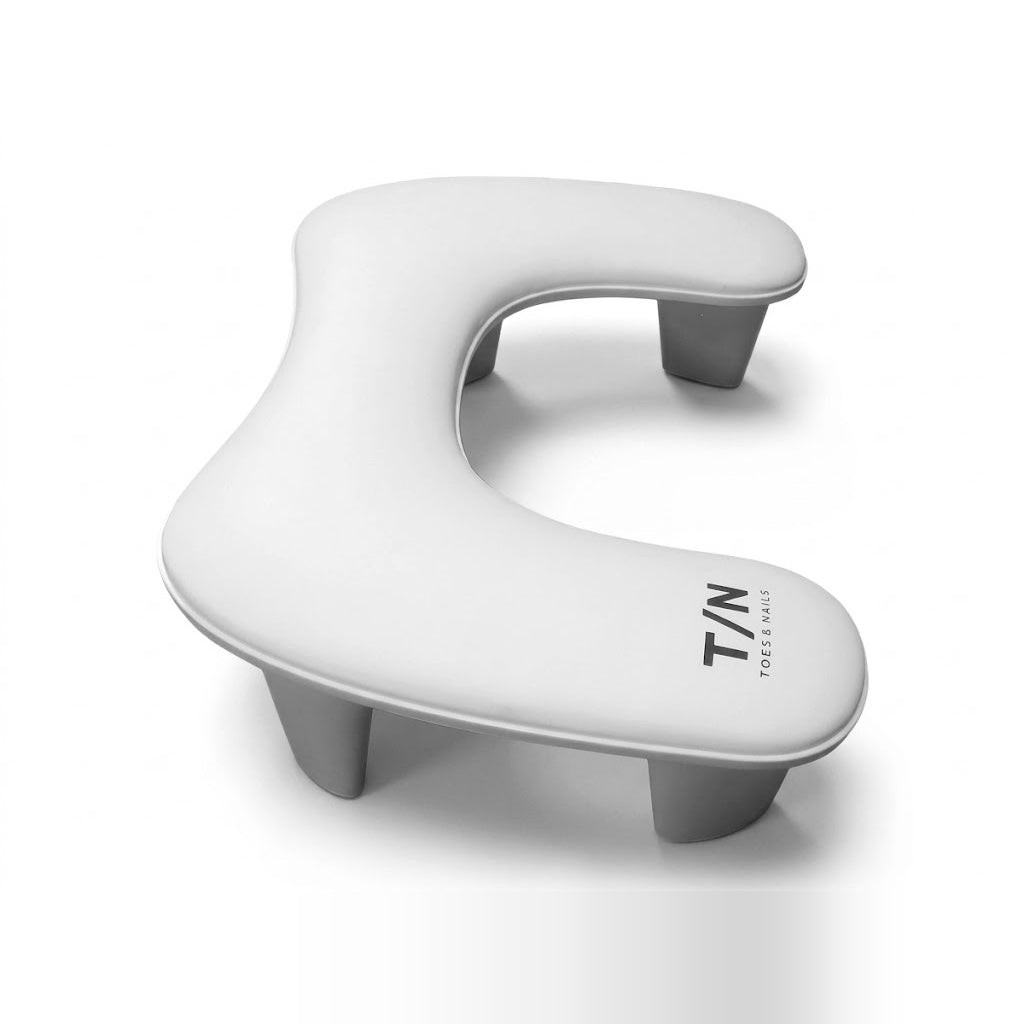 U-shaped nail arm rest on four raised legs, side angle